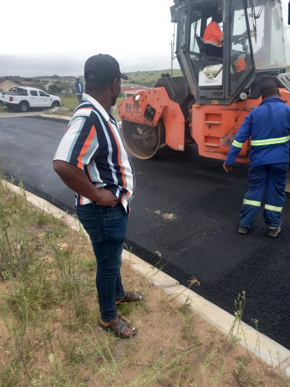 Supervisor checking asphalt rolling