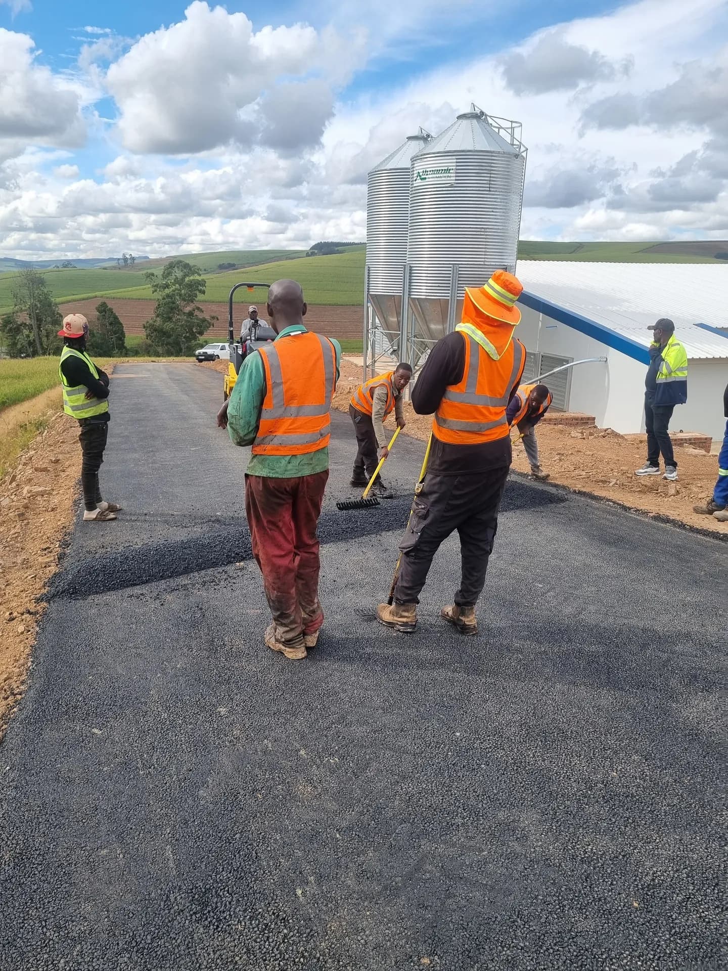Supervisors inspecting a completed asphalt road