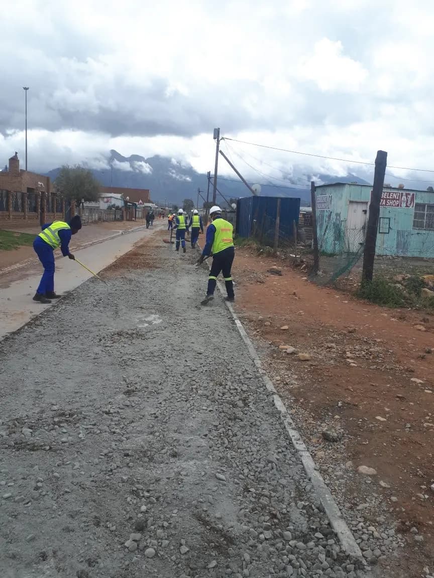 Crew spreading base material for a township road
