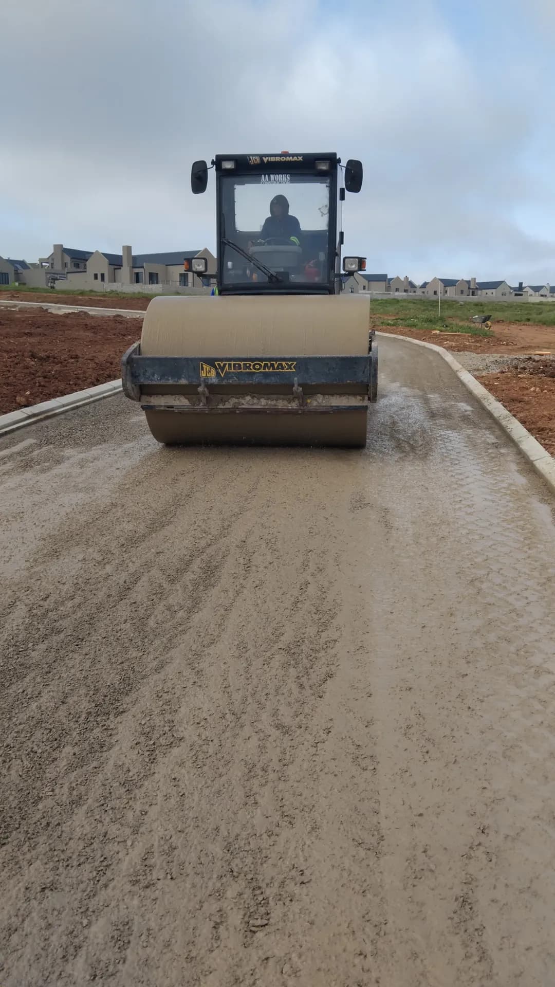 Smooth-drum roller compacting a road base